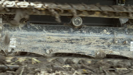 a closer shot of the track rails and rollers of a heavy duty bulldozer, a heavy equipment used for farming and buidling infrastructure