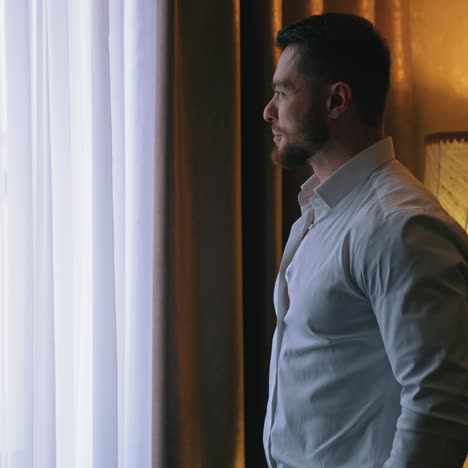 man enjoying view from hotel room