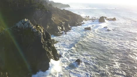 aerial drone of sue-meg state park, rocky coastline, cliffs, and waves, northern california