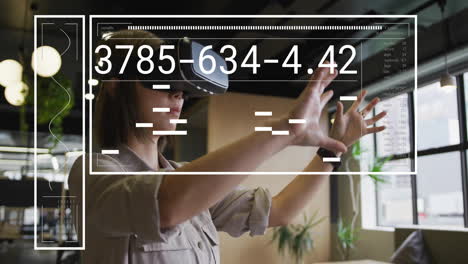 animation of financial data processing over asian businesswoman using vr headset in office
