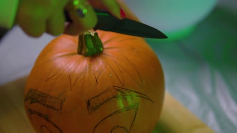 starting to carve pumpkin from the top indoor