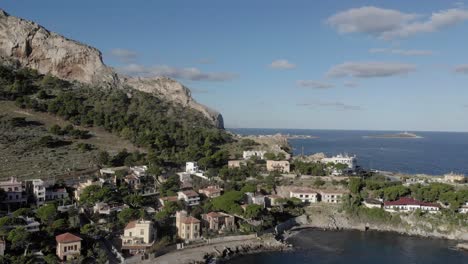 sunny sicilian coastal community aerial, waterfront homes on point