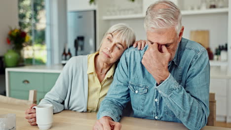 a senior couple experiencing sadness and supporting each other