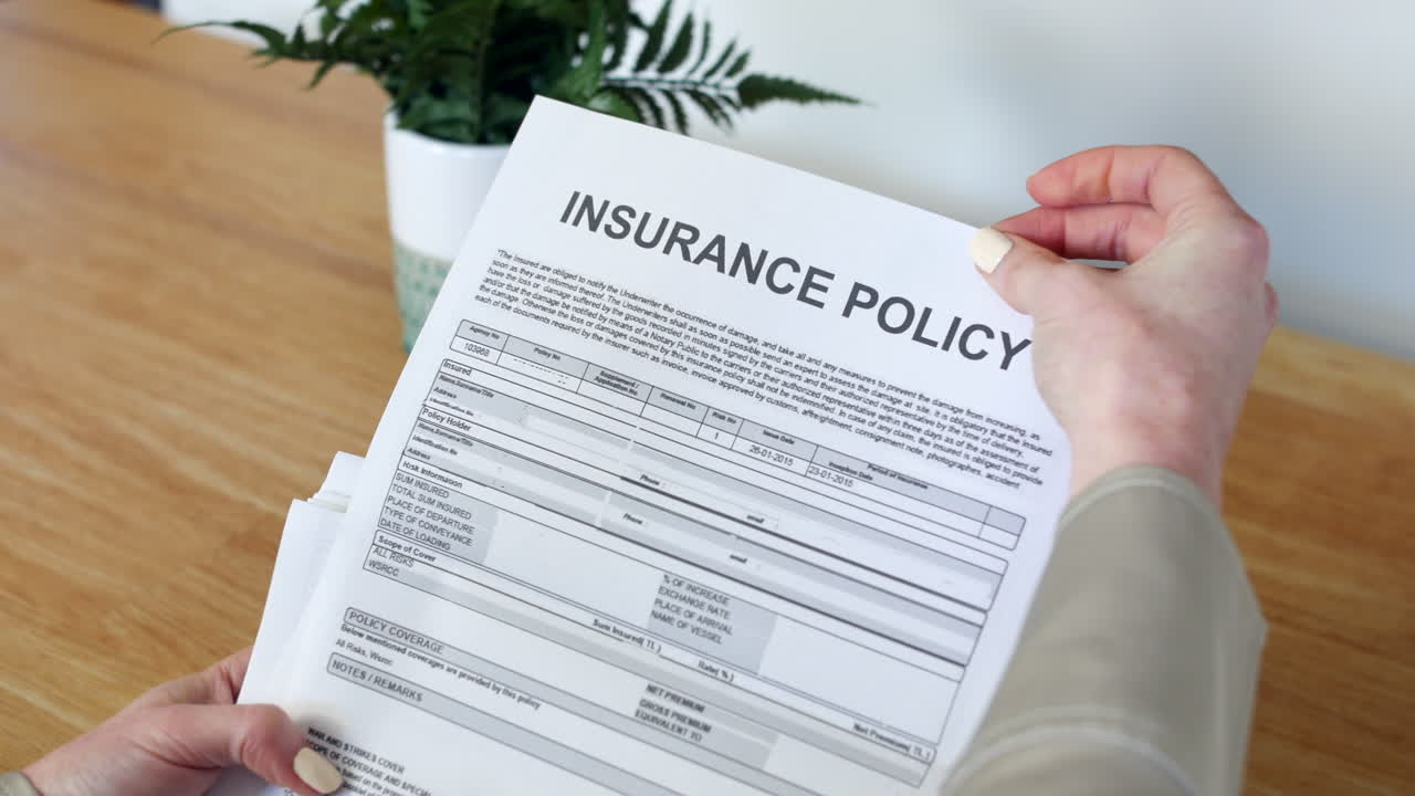 A woman opening an Insurance Document letter outlining her policy and cover details