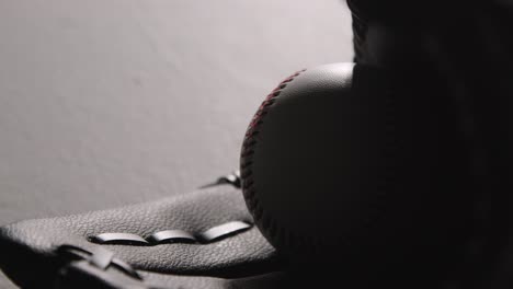 monochromatic close up studio baseball still life with bat ball and catchers mitt 1