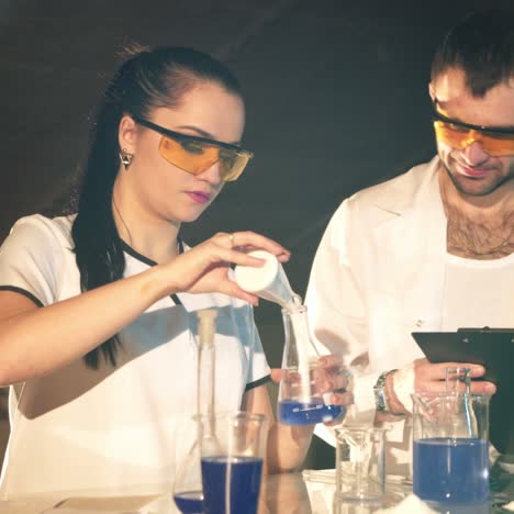 chemistry students working on an experiment together in college. research in the chemical laboratory