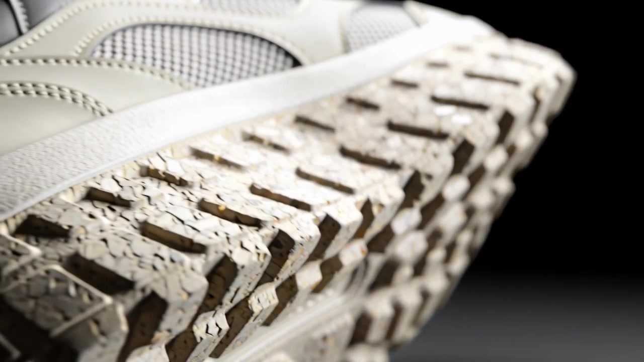 Pulling camera revealing cream sneaker in studio, showing chunky speckled lug outsole for detail