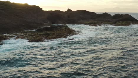 Drone-shot-of-waves-splashing-on-the-coast-of-an-ocean