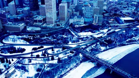 winter aerial eve flyover vintage iron low level bridge with 4 truss design built 1900 connecting the downtown area to the south side of edmonton on connors and scona rd nw over the snowy river 4k1-2