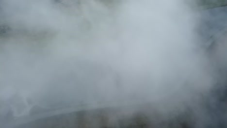 Thick-cloud-above-a-small-beautiful-reservoir-high-in-the-alps-of-Austria,-Leogang-Saalbach