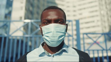 man wearing a mask in a city