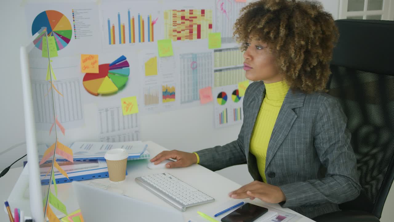 Concentrated woman watching computer in office
