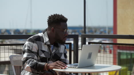 man working on laptop outdoors