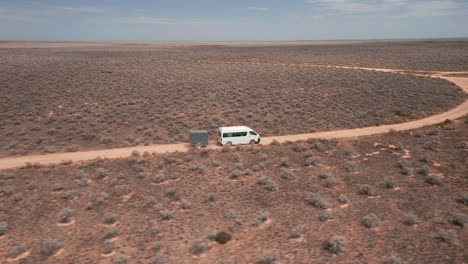 Vista-Aérea-De-Una-Furgoneta-Y-Un-Remolque,-Día-Soleado-En-Un-Desierto---Seguimiento,-Disparo-De-Drones