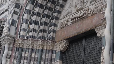 panning down clip of an ornate black and white striped cathedral archway