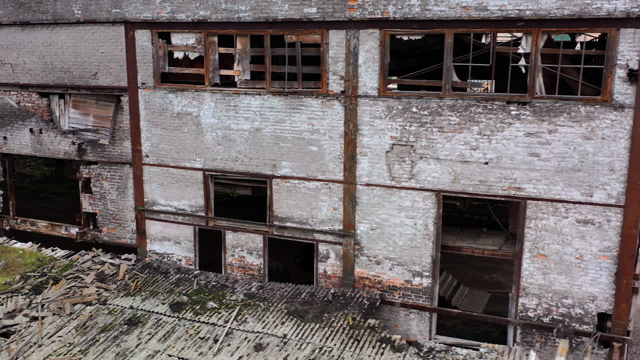 Damaged building with broken windows. Abandoned place after the war. Exterior of empty building during military actions.