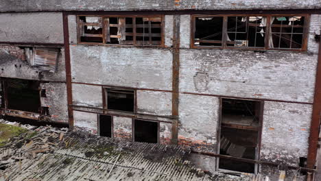 damaged building with broken windows. abandoned place after the war. exterior of empty building during military actions.