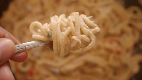creamy pasta dish on a fork