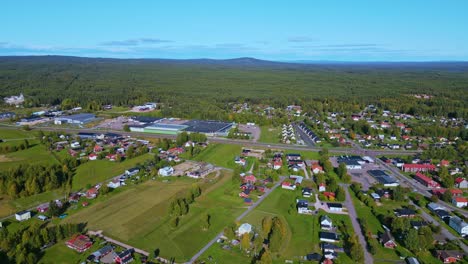 typical houses and buildings at the municipality of malung overlooking the dense forest under the blue sky in dalarna, sweden