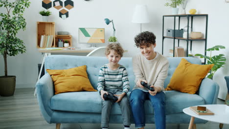 mother and son playing video games at home