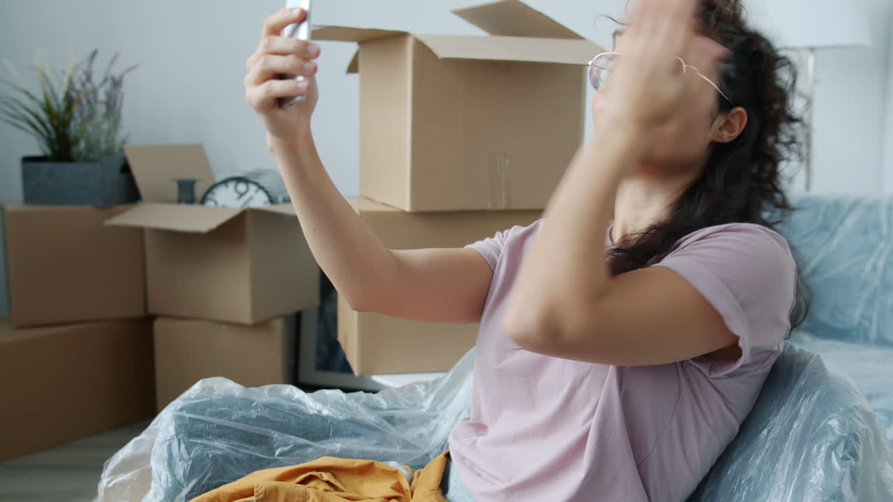 Woman taking a selfie video call during a move