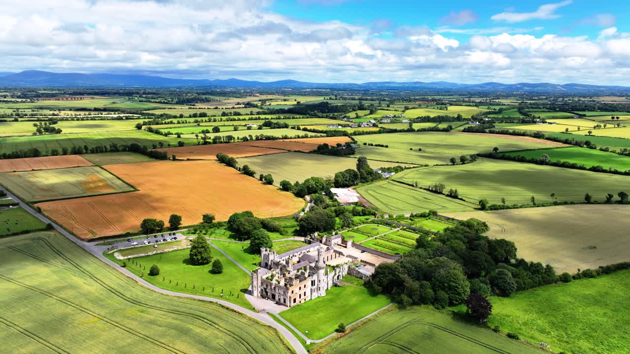Aerial view of castle ruins cloud shadows passing over fertile land Ducketts Grove Carlow Ireland epic locations