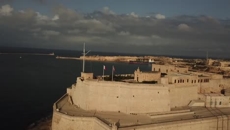 aerial view of fort st. angelo in the grand harbour of malta, europe. dolly shot flying towards the fort.