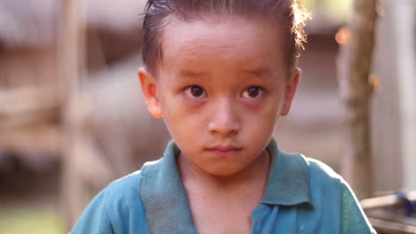 portrait of a young boy in a rural setting