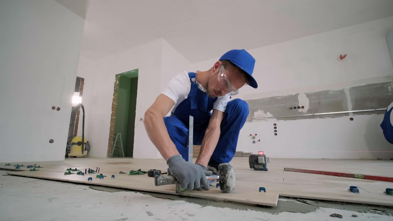 Installing ceramic floor tiles - measuring and cutting the pieces. Construction, renovation, repair apartment. Cuts tile. Tile cutting