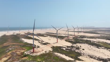 wind turbines spin along gigh aerial of branching parnaiba river delta system, brazil, with sandbars and wide open water