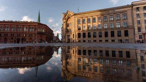 reflection of buildings in a puddle in a european city