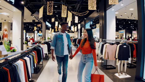 happy couple enjoying a shopping trip in a mall