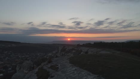 sunset over the mountain range with a city view