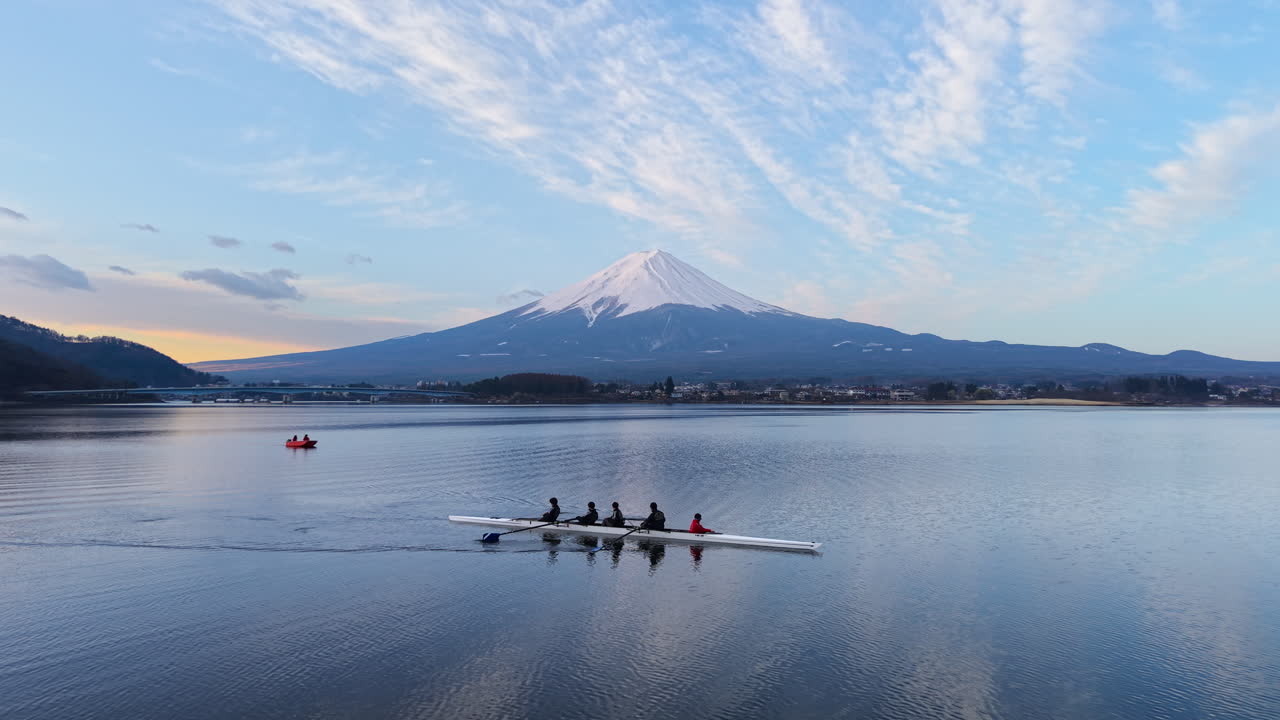 Aerial drone view of Lake Kawaguchiko near the Fujikawaguchiko town, Japan with Mount Fuji on the background in the evening