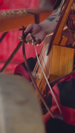 musician performs playing igil bow instrument at tribal concerts on stage closeup. traditions of altai music. meditative sound and inspiring show