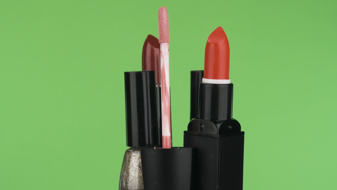 Rotation of cosmetics on a green background.
