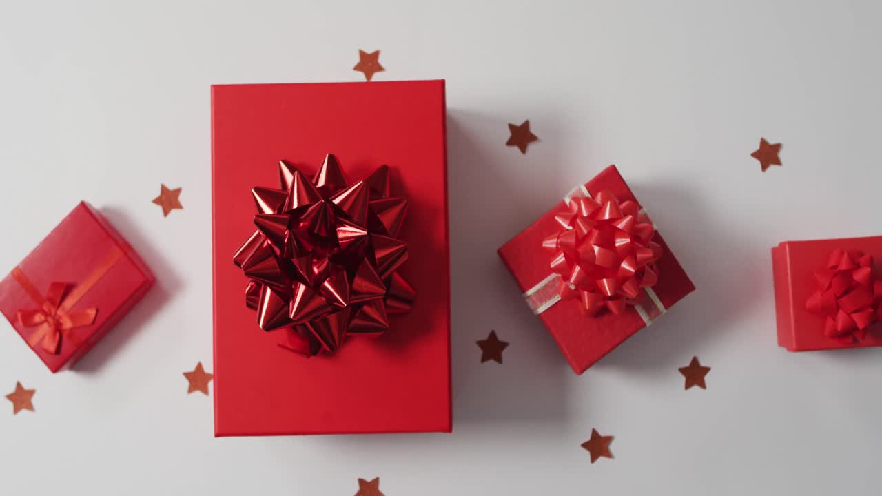 Video of red christmas presents and copy space on white background