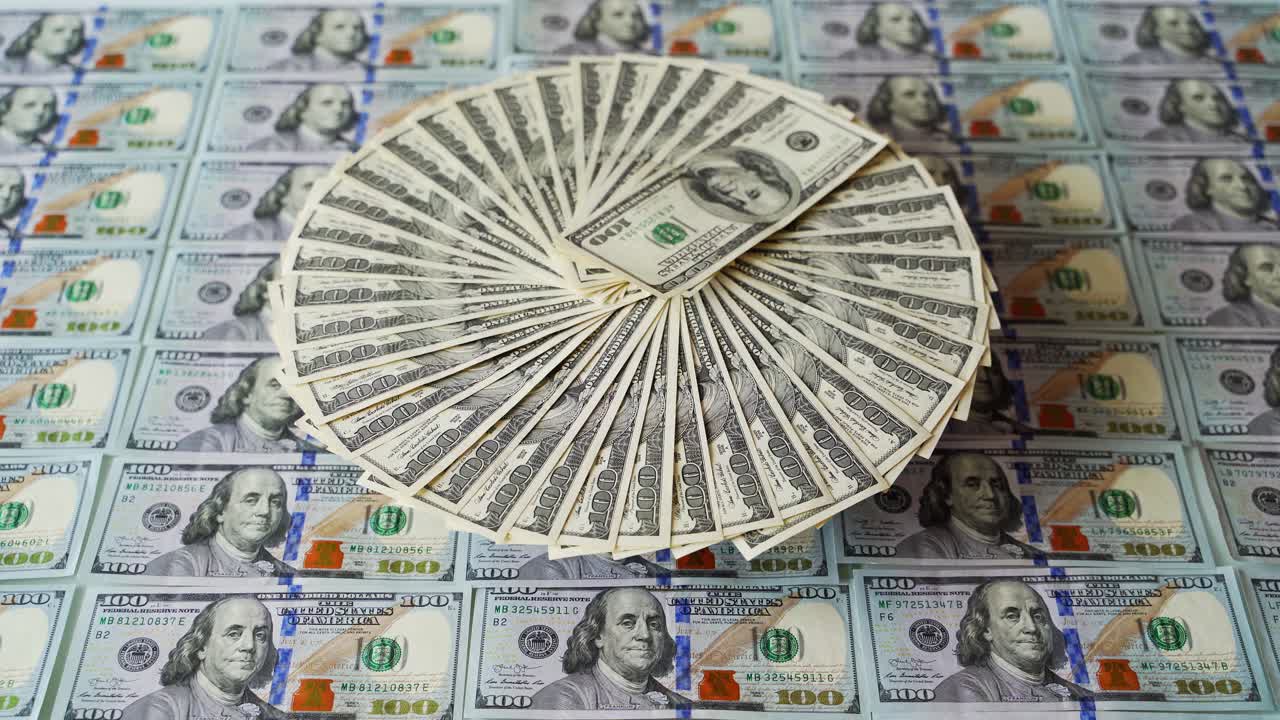 Hundred dollar banknotes. American paper money background. One hundred dollar bills rotating in a circle way. Business and finance.