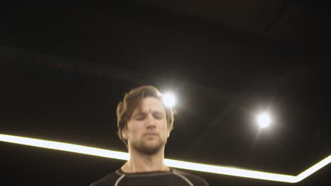 handsome sport man jumping at gym. boxer training with skipping rope on ring