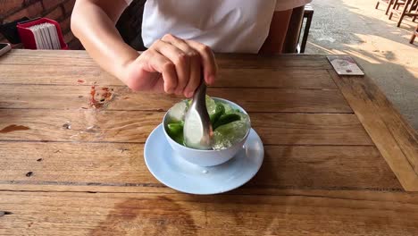 person making a green shaved ice dessert