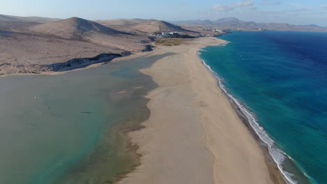 la barca beach, fuerteventura: aerial view traveling in over the shoreline of the beach and the turquoise waters