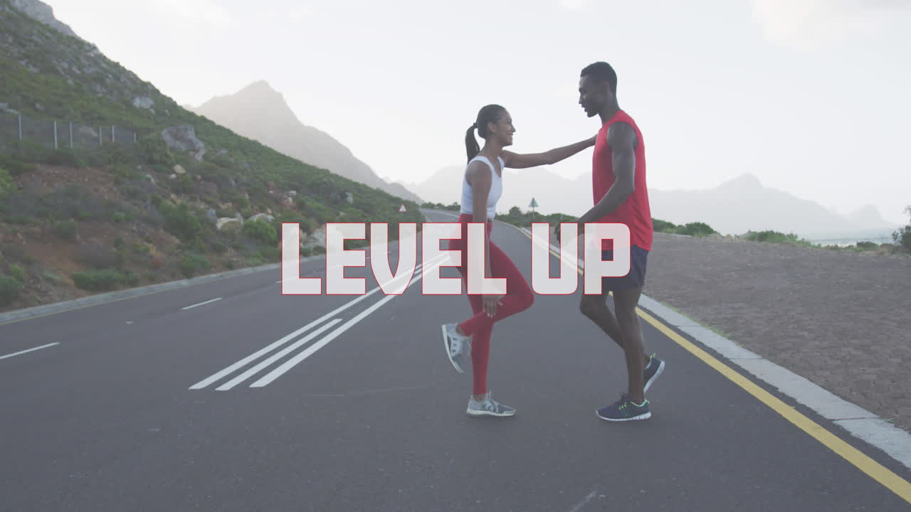 Animation of the words level up written in white over couple exercising on mountain road