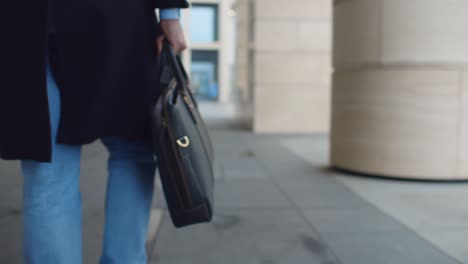 close up of businessman with briefcase walking on street