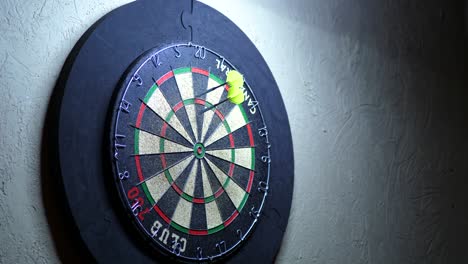 throwing magnetic needle darts of the target indoors at a club