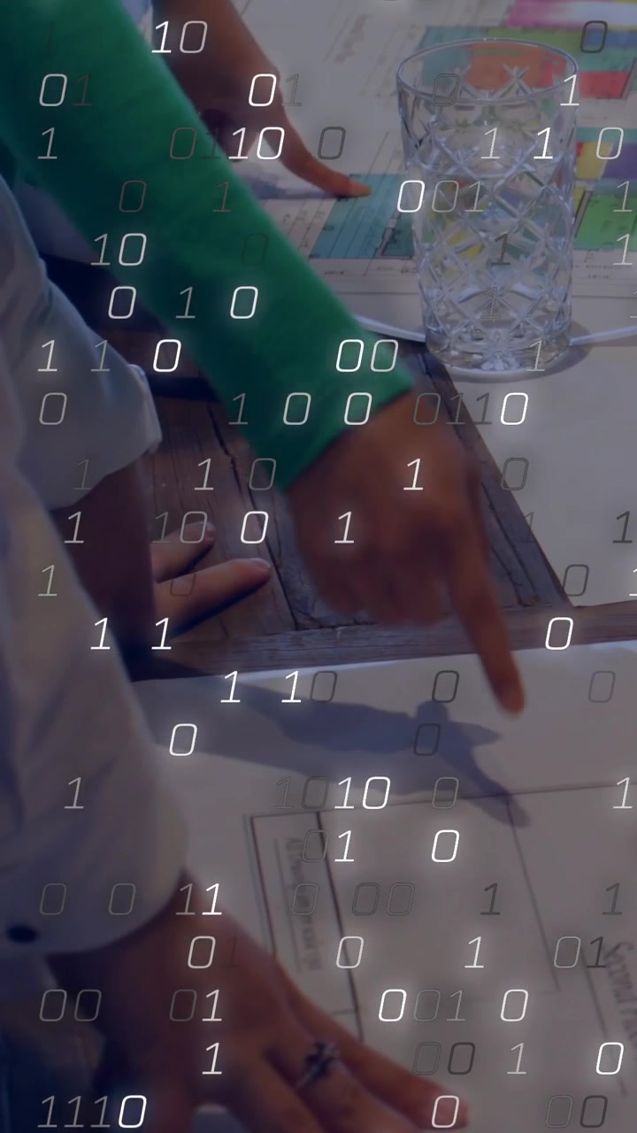 Vertical video: Camera pullback, hands pointing and pressing papers for review under binary overlay