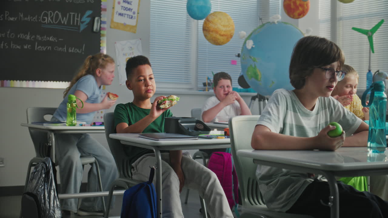 Elementary School Students Sitting at Desks Studying in Modern Classroom