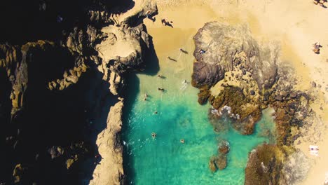 looking down on halona beach cove as families enjoy the stunning turquoise water