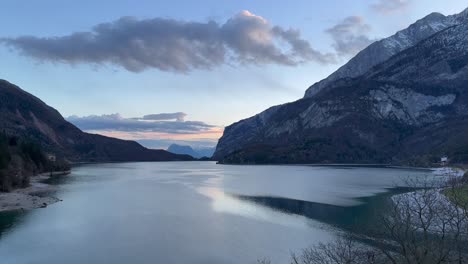 frozen lake between mountains and sky on the horizon