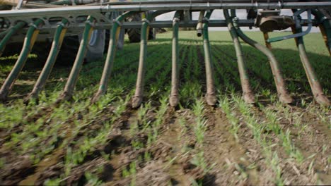 liquid manure spreader releasing slurry on field