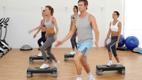 clase de aeróbicos dando pasos y aplaudiendo juntos